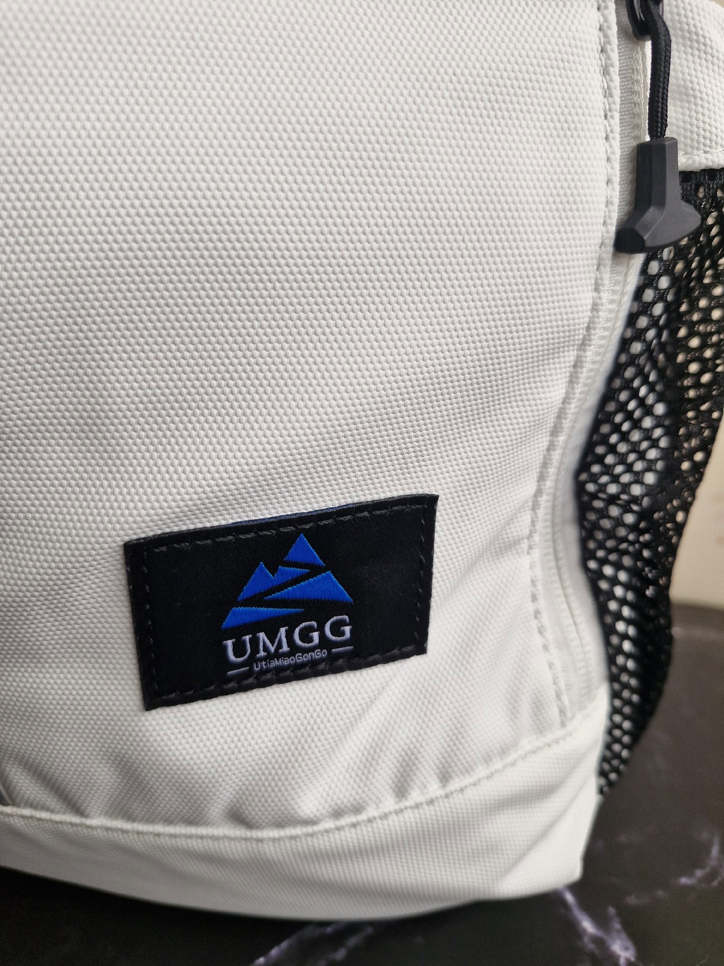 UMGG White Roll Top Backpack with Black Mesh Pockets, Umgg, One Size, New condition — preloved on SilentSale®